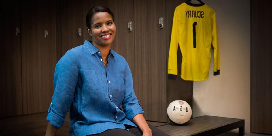 Brianna Scurry sitting on bench with 足球 ball and jersey in the background